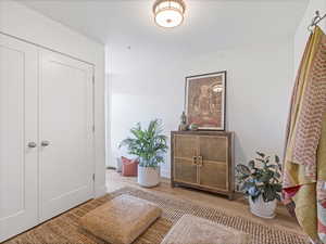 Entryway with wood finished floors and a textured ceiling