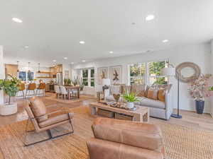 Living room with recessed lighting and light wood-style floors