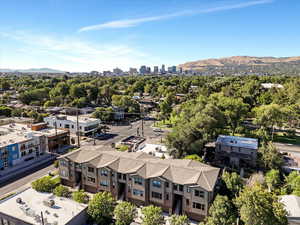 Drone / aerial view of a mountain backdrop and city skyline