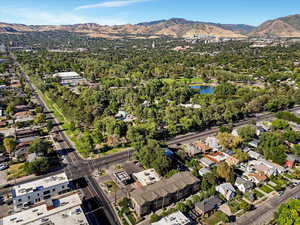Aerial view of property and surrounding area with a water and mountain view and nearby suburban area