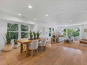 Dining area with light wood-style flooring and recessed lighting