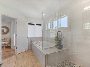 Full bathroom featuring a garden tub, a tile shower, and tile patterned floors