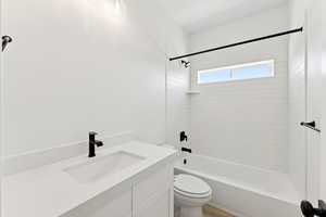 Full bathroom with shower / bath combination and vanity