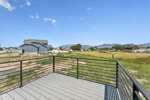Wooden deck featuring a residential view and a mountain view