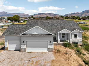 View of front of house with board and batten siding, stone siding, and a mountain view