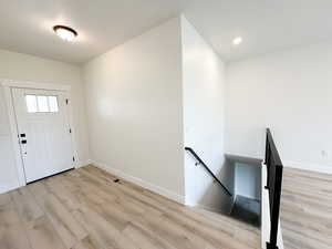 Entryway featuring light wood-type flooring and baseboards