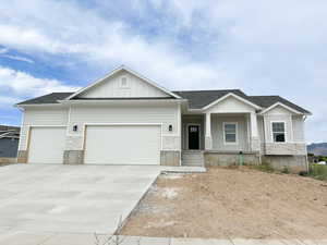 Craftsman house with board and batten siding, stone siding, and a porch