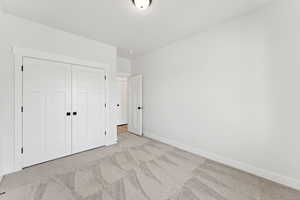 Unfurnished bedroom with carpet floors and a closet