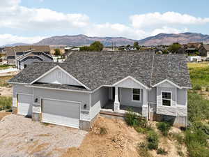 View of front facade featuring a shingled roof, board and batten siding, and a mountain view