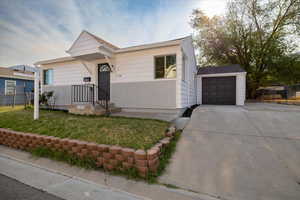 View of front of property with concrete driveway and a garage