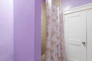 Full bathroom featuring curtained shower