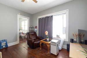 Living area featuring hardwood / wood-style floors and a ceiling fan