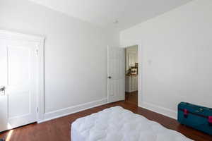 Bedroom featuring wood finished floors and baseboards