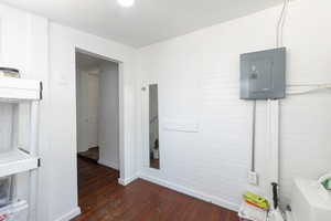 Interior space with electric panel and wood finished floors