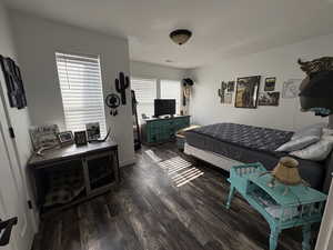 Bedroom with dark wood-style flooring