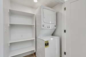Washroom featuring stacked washer / dryer