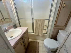 Full bathroom with vanity and shower / bath combination with glass door