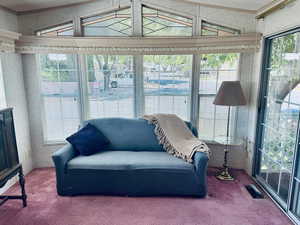 Sunroom featuring carpet and lofted ceiling
