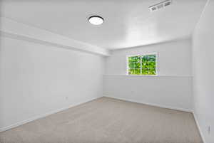 Spare room with carpet floors, ornamental molding, and a textured ceiling
