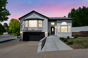 View of front of home featuring an attached garage and concrete driveway