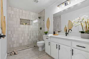 Bathroom featuring vanity, walk in shower, crown molding, and a textured ceiling