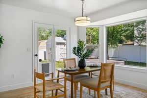 Dining room featuring light wood-style flooring and baseboards