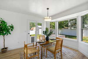 Dining area featuring light wood-style flooring and a textured ceiling