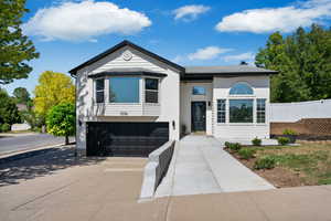 View of front of house featuring an attached garage and concrete driveway