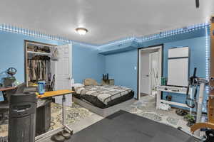 Bedroom with a closet and a desk