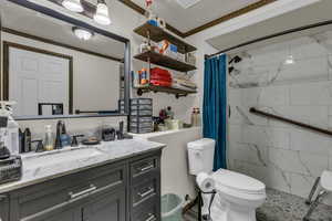 Bathroom featuring vanity and a tile shower