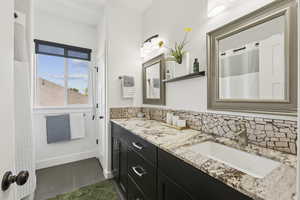 Bathroom with tasteful backsplash and double vanity