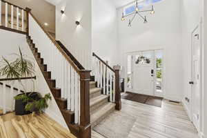 Foyer entrance featuring stairway and wood tiled floors