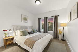 Bedroom with baseboards and carpet flooring