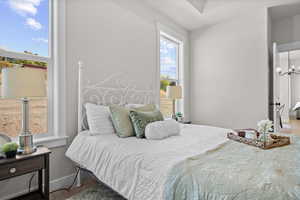 Carpeted bedroom featuring baseboards and a chandelier