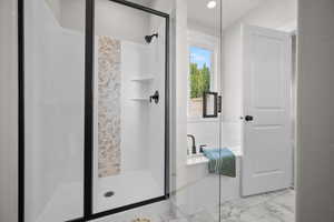 Bathroom with a stall shower, marble finish floors, and recessed lighting