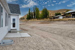 View of yard featuring a mountain view, entry steps, and a patio