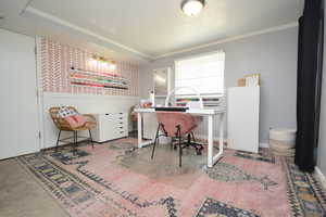 Office space with wallpapered walls, crown molding, and a textured ceiling