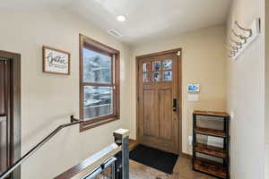 Tiled foyer with baseboards
