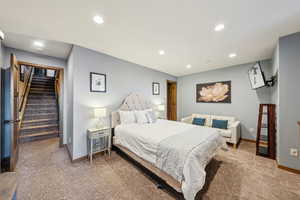 Carpeted bedroom featuring recessed lighting and baseboards