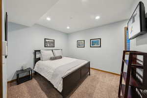 Carpeted bedroom featuring recessed lighting and baseboards