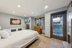 Bedroom with light carpet and recessed lighting