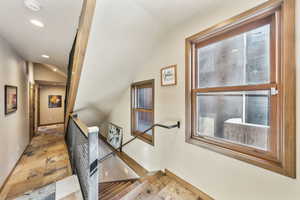 Stairway featuring stone tile flooring and recessed lighting