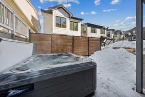 View of patio / terrace with a hot tub and a residential view