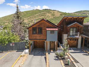 Chalet / cabin with a mountain view, a metal roof, a balcony, and a standing seam roof