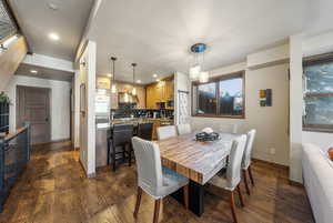 Dining space with recessed lighting and dark wood finished floors