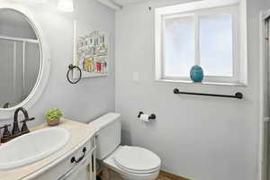 Full bath with vanity and a shower with door