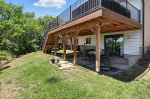 Back of property with a yard and a patio