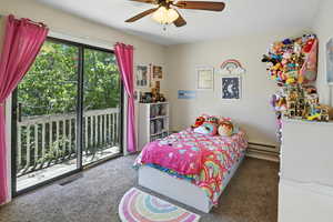 Carpeted bedroom with access to exterior, a baseboard radiator, and ceiling fan