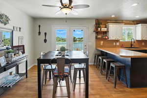 Dining room featuring a textured ceiling, a ceiling fan, light wood-type flooring, and recessed lighting