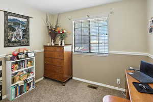 Carpeted office with baseboards